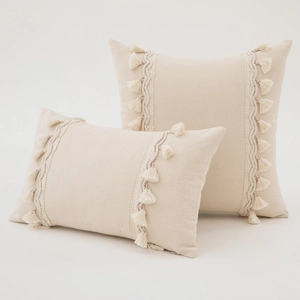 Set of two beige bohemian pillow covers with tassel fringe and woven cotton linen texture