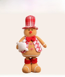 Macro detail of gingerbread man plush with corduroy texture and festive knit attire