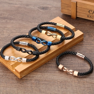 Men's woven leather bracelets with infinity symbol and metal magnetic clasps on wood