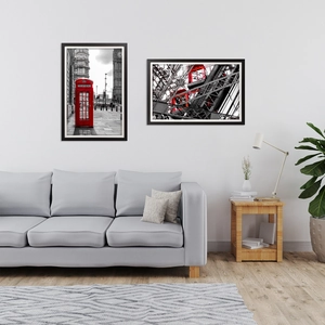 Modern rectangular black wooden photo frames with red accent art in a minimalist living room