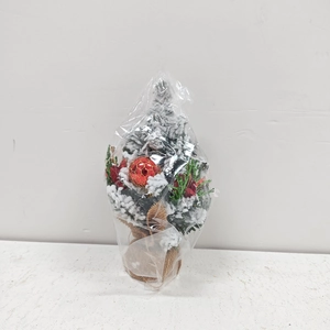 Mini tabletop Christmas tree with snow spray, red berries, and natural burlap base