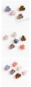 Detailed view of 3cm acetate claw clips with marble and floral patterns on a ruler