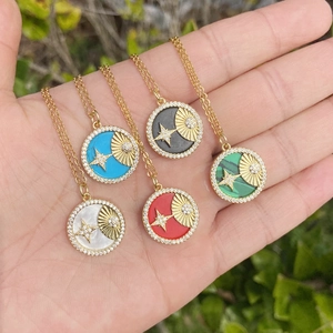Detail showing 18K gold star and moon necklaces with colorful enamel pendants and zircon