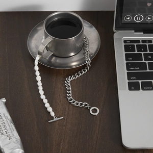 Detail of freshwater pearl and silver titanium steel chain necklace with OT buckle closure