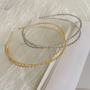 Detail view of double-layered metal headbands with rhinestones in gold and silver