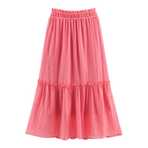 Detail of vibrant pink pleated maxi skirt with ruffled hem and elastic waistband textures