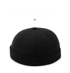 Detail of black cotton docker cap featuring high-quality red ship wheel embroidery