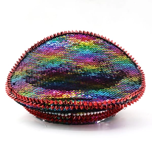 Macro detail of rainbow sequins and red studs on a festival party captain hat