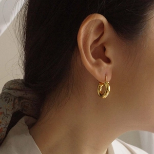 Minimalist gold hoop earrings for women featuring a bold retro circular design
