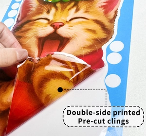 Detail of double-sided printed Christmas cat static cling being peeled for window display