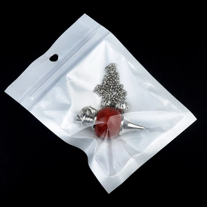 Natural red agate crystal sphere pendulum pendant with silver chain on black background