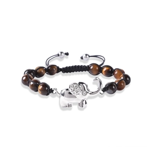 Detailed close-up of tiger eye stone beads and silver elephant charm with rhinestones