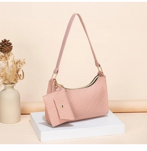 Detail of pink woven texture shoulder bag with matching mini envelope pouch and metal zipper