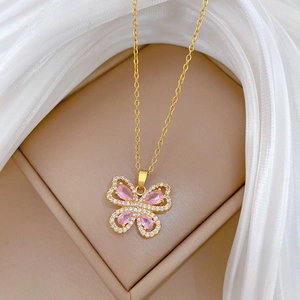Luxurious gold butterfly necklace with pink pear-shaped stone and sparkling crystals