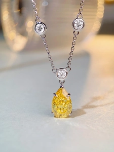 Macro shot of s925 silver necklace with pear-cut yellow gemstone and zircon pavé accents