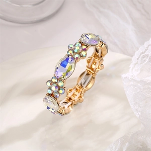 Macro shot of gold alloy bracelet featuring iridescent AB crystals and floral patterns