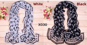 Close-up of pirate skull print on white and black chiffon scarves with X030 detail