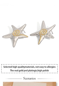 Macro detail of starfish earrings with silver texture and golden center spiral