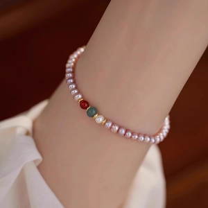 Elegant natural freshwater pearl bracelet with agate and gold beads on a wrist