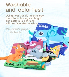 Detail of washable baby cloth book showing 3D shark tail and textured fabric material