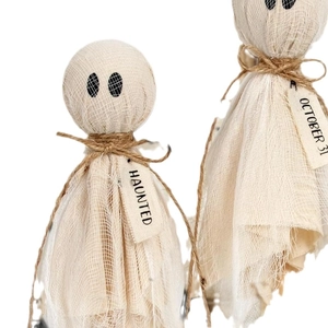 Detailed close-up of handmade Halloween ghost ornaments with Haunted and October 31 tags