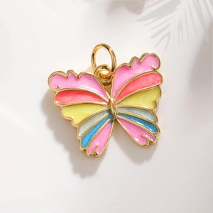 Colorful butterfly pendant in gold-plated metal and enamel on a white background