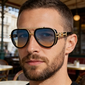 Detail of aviator sunglasses with gold frames and gradient lenses in punk style