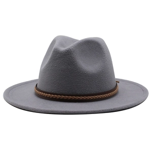 Detail of grey wool jazz hat featuring a brown braided leather band on white background