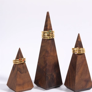 Detailed view of colorful round birthstone rings stacked on wooden display stands