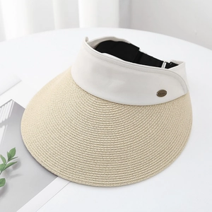 Detail of beige straw brim and white canvas headpiece with a small metallic logo