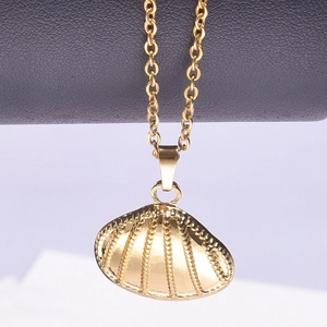 Detailed macro shot of a 18k gold plated shell pendant with textured finish and O-chain