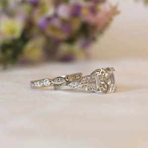 Macro side view of cushion-cut luxury bridal ring set with floral marquise stone settings