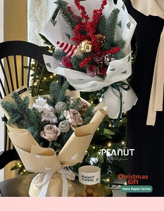 Detailed view of Christmas bouquet wrapping with pine branches and festive ribbons