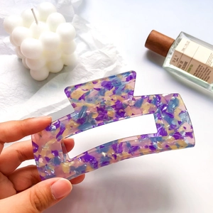 Macro detail of large 13cm purple tortoiseshell hair claw clip with acetate texture