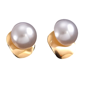 Detail of oversized grey pearl stud earrings with wavy gold-plated metal base accents