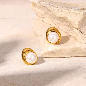 18K gold-plated stainless steel teardrop pearl earrings on a natural sandstone surface