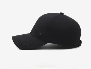 Detail of black cotton baseball cap showing side metal JR logo and stitched brim