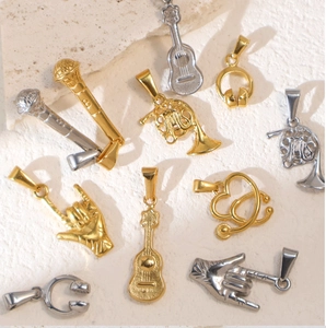 Macro shot of assorted gold and silver stainless steel pendants of musical instruments