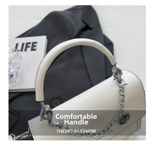 Detail of white leather shoulder bag featuring a silver metal chain and round brand tag