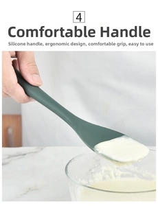 Detail of dark green heat-resistant silicone spatula for non-stick pan stirring