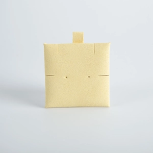 Macro shot of square beige microfiber jewelry insert pad with delicate velvet texture