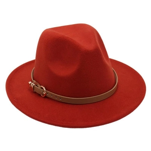 Detail of red wool fedora with brown faux leather band and rose gold metal buckle
