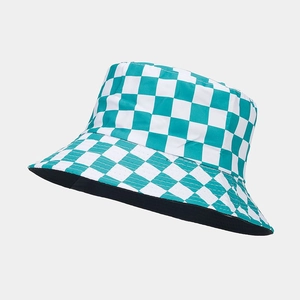 Detailed 45-degree angle view of a green and white checkerboard reversible bucket hat