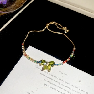 Detail of adjustable gold bracelet with colorful zircon butterfly and draw-string buckle