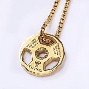 Detail of golden barbell weight pendant with inspirational quotes for fitness motivation