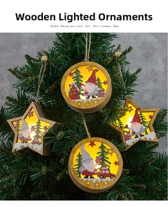 Detail of four-piece wooden Christmas gnomes ornaments with warm LED lighting on tree