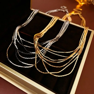 Luxury multilayer snake bone necklaces in gold and silver finish on velvet box