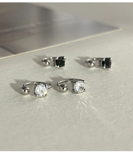 Detail of 925 sterling silver ear cuffs with clear and black cubic zirconia stones