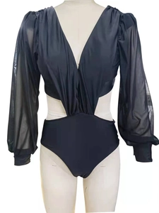 Detail of black one-piece swimsuit with deep V-neck, waist cutouts, and sheer mesh long sleeves