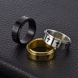Set of three rotating stainless steel cross rings in black, gold, and silver finishes